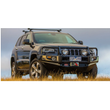The Old Man Emu jeep grand cherokee is parked in a field with increased ride height due to the installation of ARB Front Coil Springs 2990 for Jeep Grand Cherokee WJ & WG (2005-2010) - V8 PETROL & DIESEL.