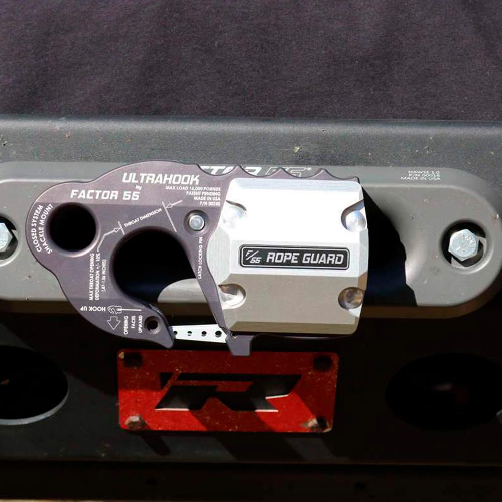 A lightweight Factor 55 UltraHook Winch Shackle Aluminum 00250-06 latch, made of 7000 series Military Grade Aluminum, is attached to the side of a vehicle.