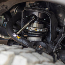Load image into Gallery viewer, An image featuring Old Man Emu BP-51 shock absorbers on a vehicle suspension system, delivering exceptional off-road performance with adjustable damping.