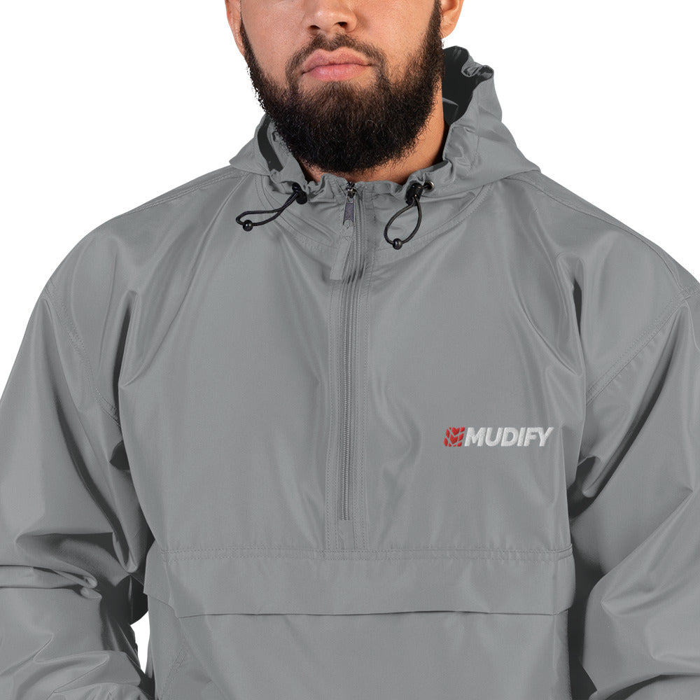 A man with a beard wearing a wind and rain resistant, Mudify Embroidered Mudify Packable Jacket.