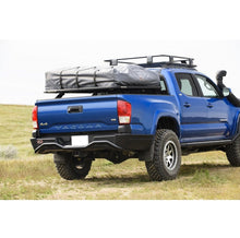 Load image into Gallery viewer, A blue Toyota Tacoma with a roof rack on it, equipped with the ARB Summit Rear Bumper 3623040 For Toyota Tacoma 2016-2023 and a tow hitch.