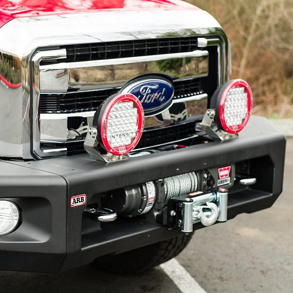 The front end of a red ARB Ford F-250 SUPER DUTY (2011-2016) pickup truck with winch compatibility and larger tubing, specifically the Kit Textured Modularbar Type C.