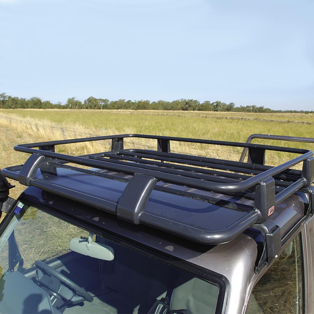 A Toyota ARB with a Steel Roof Rack Basket with Mesh Floor on top of it, providing secure storage for outdoor gear.