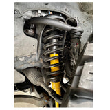 A vehicle with OME Front Upper Control Arms for Toyota Hilux (2005-2022) UCA0003 Old Man Emu attached to it, undergoing a suspension lift.