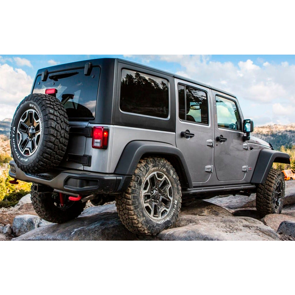 The Old Man Emu adjustable jeep wrangler is parked on a rock, supported by sturdy DOM steel tube control arms.