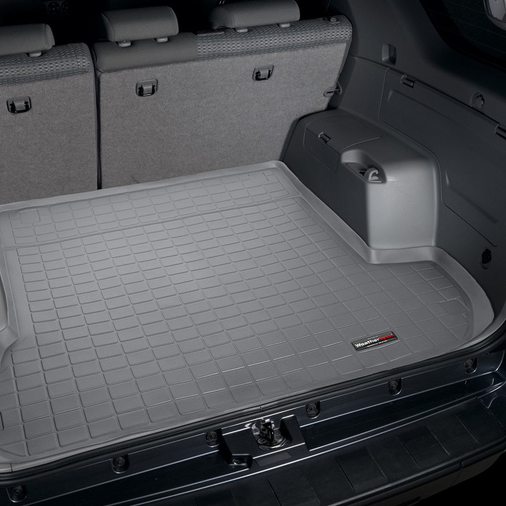 The back of a SUV with a Weathertech Cargo Liner for Toyota 4Runner (2003-2009) gray trunk liner.