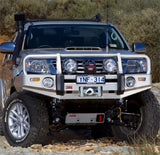 An ARB Toyota Hilux SUV with steel components is parked on a rocky area.