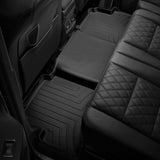 The back seat of a car with Weathertech Floorliner HP 2nd Row Floor Mats for Toyota Tacoma 2018-ON (Access Cab Models) providing interior protection.
