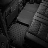 The back seat of a car with Weathertech DigitalFit 1st & 2nd Row Floor Liners for Toyota Tundra (2022-ON) providing interior carpet protection.