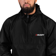 Load image into Gallery viewer, A man with a beard is wearing the Mudify Embroidered Mudify Packable Jacket, a wind and rain resistant black jacket with the word muddy on it.