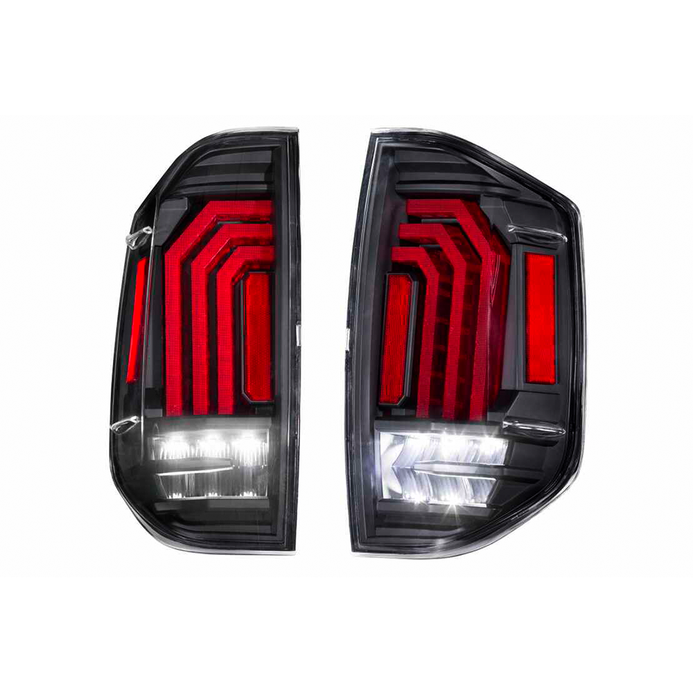 A pair of black and red Morimoto XB LED tail lights for the Ford F-150, offering aftermarket performance with Morimoto XB LED headlights.