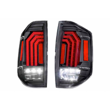 Load image into Gallery viewer, A pair of black and red Morimoto XB LED tail lights for the Ford F-150, offering aftermarket performance with Morimoto XB LED headlights.