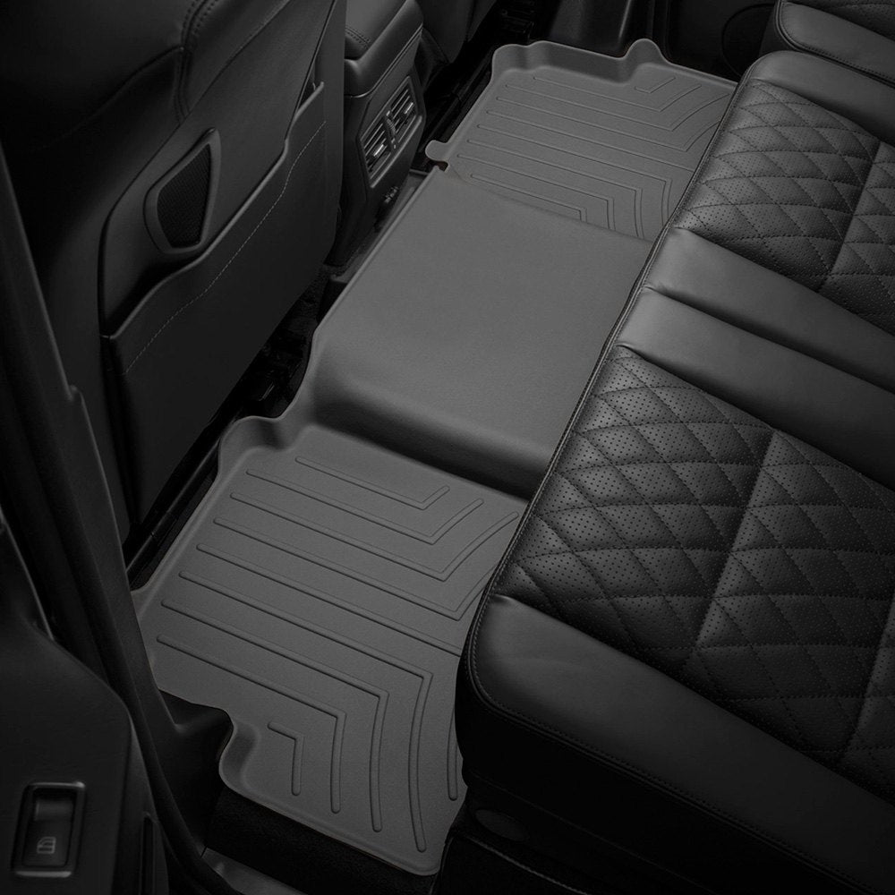 The back seat of a Toyota Tacoma 2018-ON (Double Cab Models) SUV equipped with Weathertech Floorliner HP 2nd Row Floor Mats made from a Thermoplastic Elastomer (TPE) compound, providing optimal protection against extreme weather conditions.