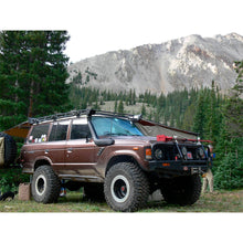Load image into Gallery viewer, An Old Man Emu Toyota Land Cruiser parked next to a mountain, showcasing its impressive suspension performance.