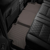 The back seat of a SUV with Weathertech Floorliner HP 2nd Row Floor Mats for Toyota Tacoma 2018-ON (Double Cab Models) for protection in extreme weather conditions.