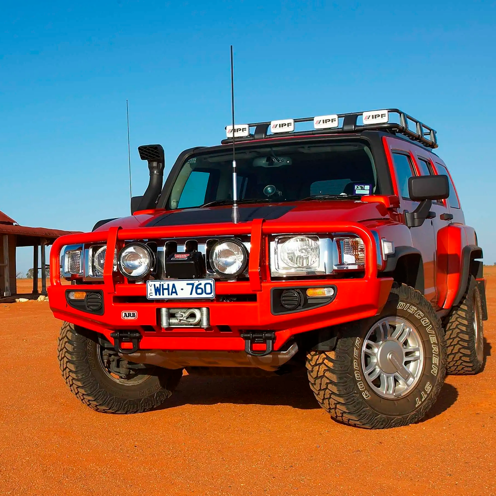 An ARB Roof Rack Fitting Kit for Toyota Land Cruiser 200 Series, model number 3715010, parked on a dirt road.