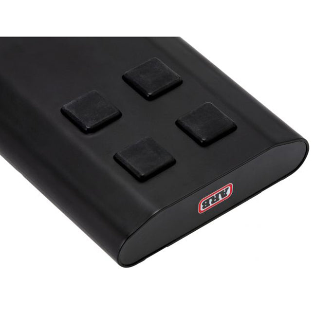 A lightweight and portable ARB Fride Portable Power Pack Accessory for Zero Fridge Freezer 10900050 with four buttons on it.