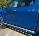 A budget-friendly, blue ARB Summit Step Section For Toyota Hilux Revo/Rocco (2015-2022) 4414620 is parked on a dirt road.