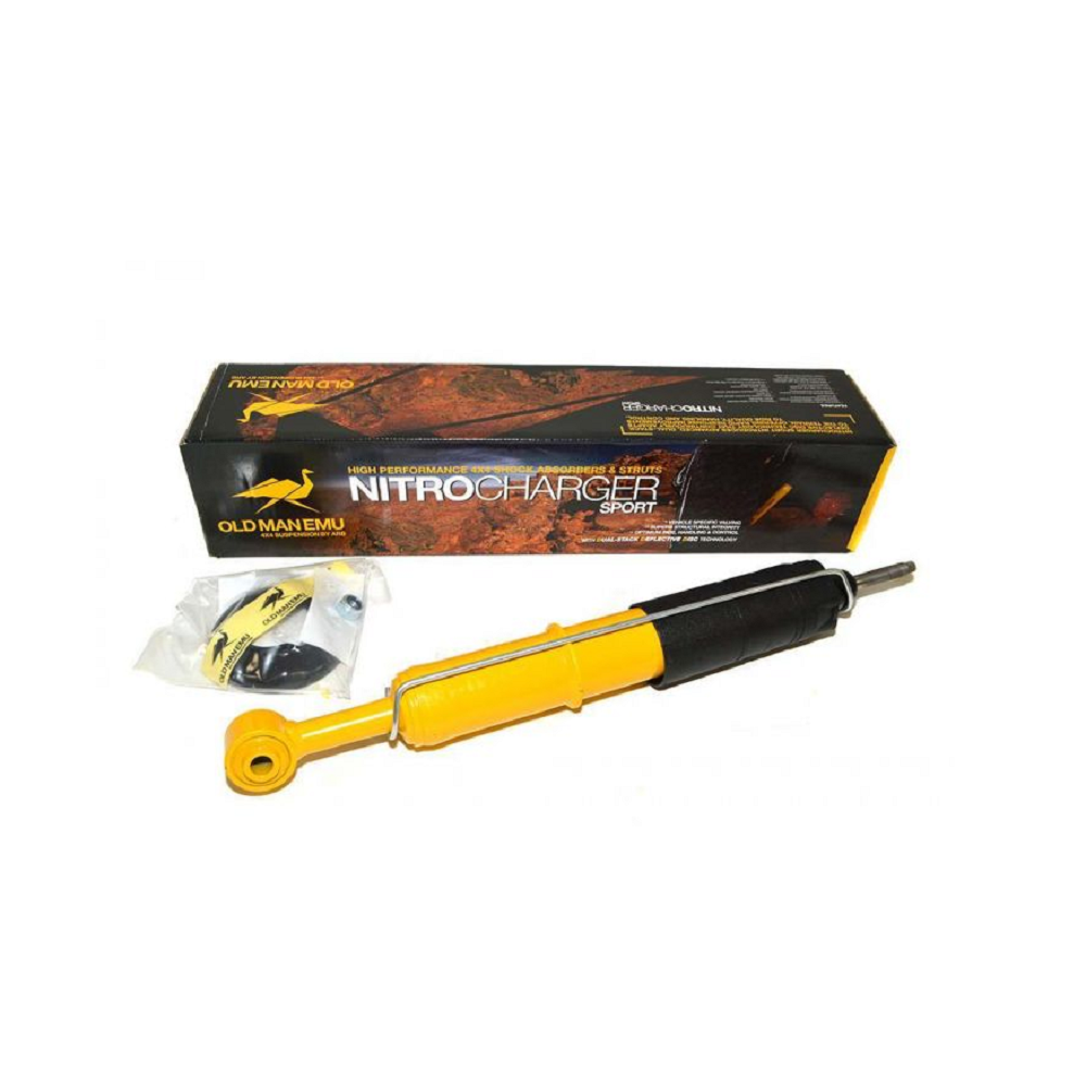 A high-quality Old Man Emu yellow shock absorber in a box, featuring compression valving and filled with nitrogen gas.