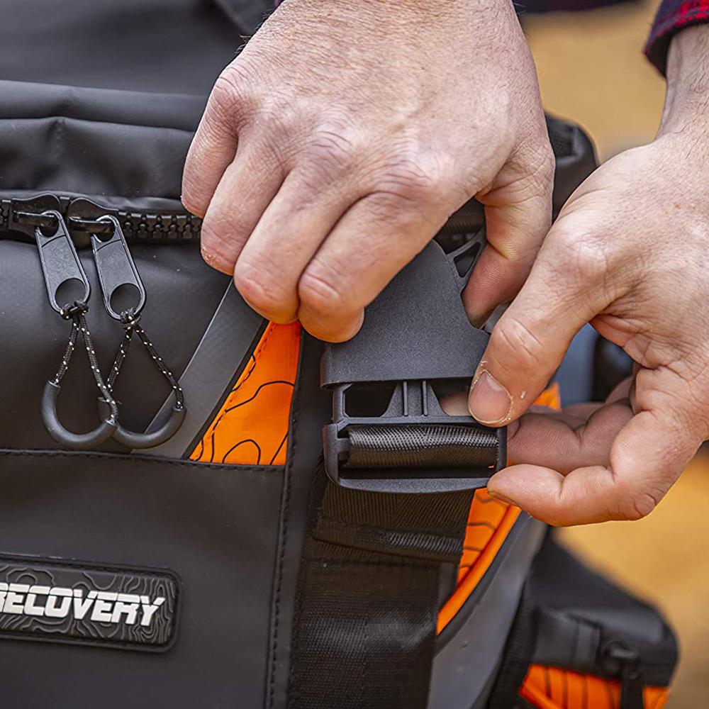 A person is holding an ARB Orange Large Recovery Bag ARB501A backpack.