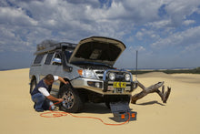 Load image into Gallery viewer, The lightweight ARB Toyota Land Cruiser effortlessly navigates the sandy terrain with its vehicle-mounted configurations, powered by the ARB Portable Air Compressor High Output Kit CKMP12.