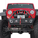 A red jeep with a front bumper equipped with a Factor 55 Warn 89611 ZEON 10-S Winch with Synthetic Rope - 10000 lb. Capacity.