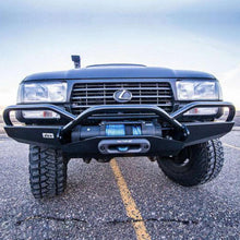 Load image into Gallery viewer, The front end of a black truck with a high capacity bumper, featuring the Factor 55 Hawse Fairlead 1.0&quot; Gunmetal 00016, providing oxidation protection and easy use.