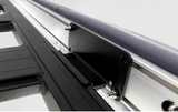 A close up of a metal rail with an ARB BASE Rack Awning Bracket 1780240 attached to a vehicle.