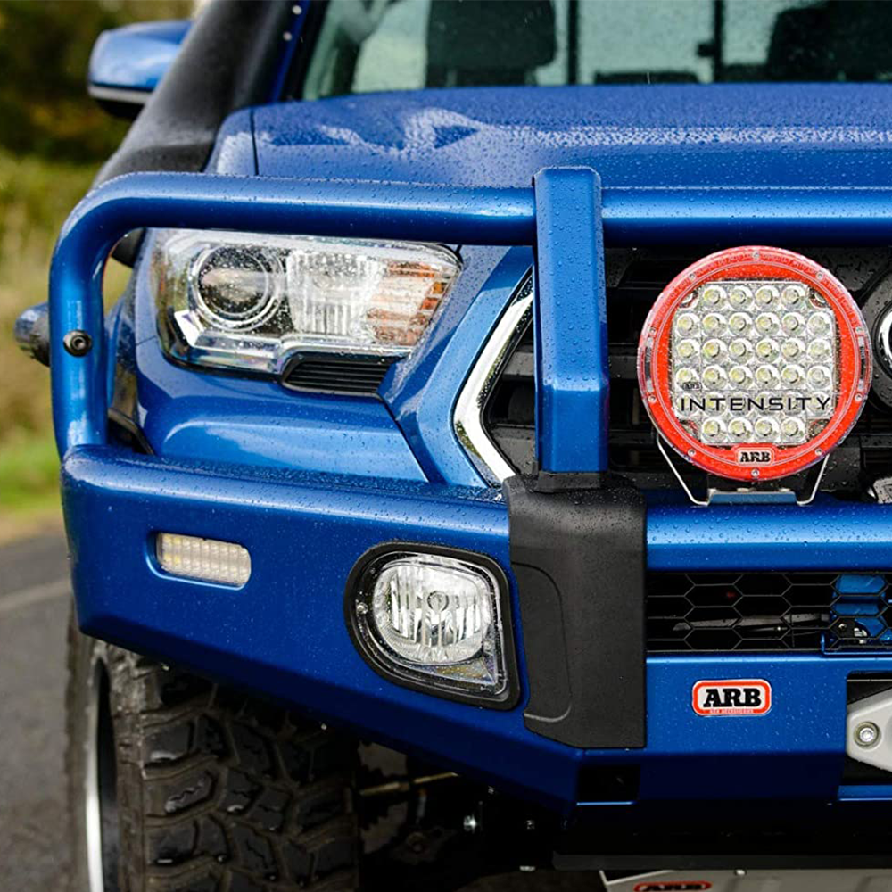 A blue ARB Toyota Tacoma with a Front Summit Bumper for Toyota Tacoma 2016-2022 ARB 3423160K grille and fog lights.
