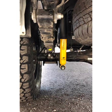 Load image into Gallery viewer, The underside of a vehicle with an Old Man Emu Rear Leaf Spring CS055R for Toyota Tundra (2007-2022) designed for enhanced ride comfort.