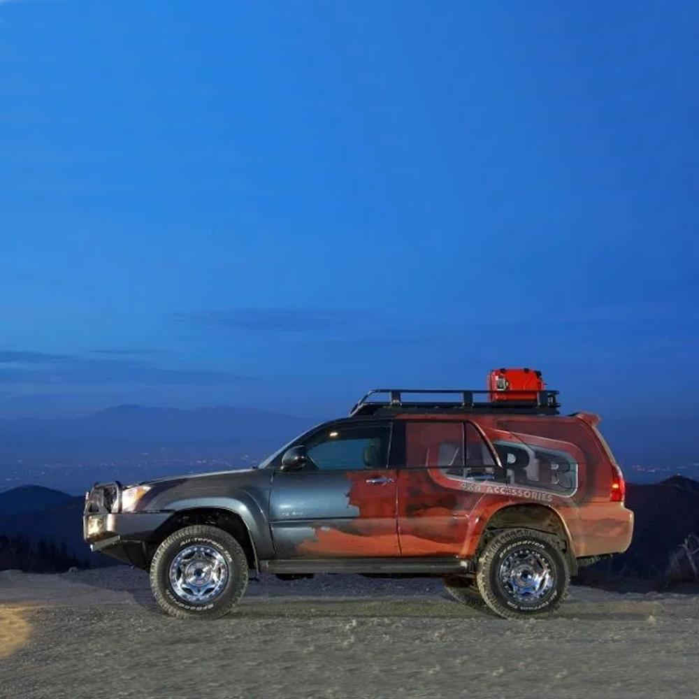 An ARB Alloy Roof Rack Basket 87” X 49” ARB 4900010M securely parked on top of a mountain at night.