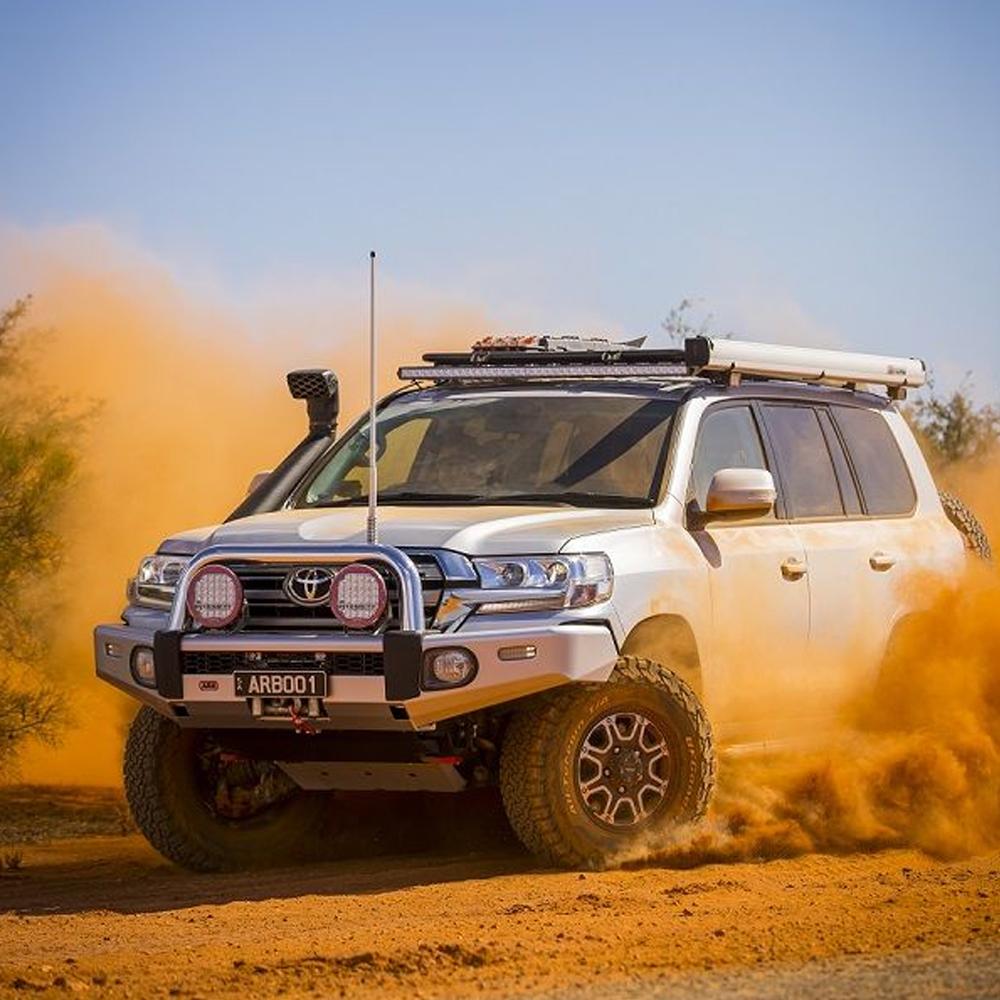 An ARB steel flat rack 87" x 44" for Toyota Land Cruiser 200 Series 2008 - 2021, with high capacity secure storage, driving through the desert.
