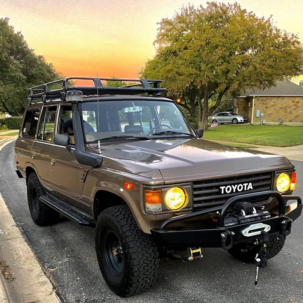 A brown ARB Toyota Land Cruiser parked on the side of the road, offering high capacity and secure storage for all your belongings.