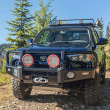 Load image into Gallery viewer, The ARB Toyota 4Runner with ARB Touring Roof Racks 3813200KJK is parked on a dirt road with crossbars for carrying capacity.
