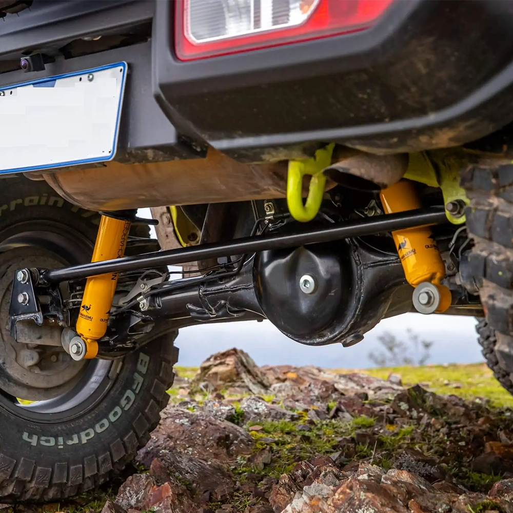The rear suspension of a jeep wrangler is built for optimal performance and durability. It utilizes the ARB Old Man Emu Front Nitrocharger Sport 60154 for Suzuki Jimny (4th Gen) 4 Cylinder 1.5L Petrol Engine All Models by Old Man Emu, a high-quality oil for smooth operation and features compression valving to enhance control and handling. Additionally, the