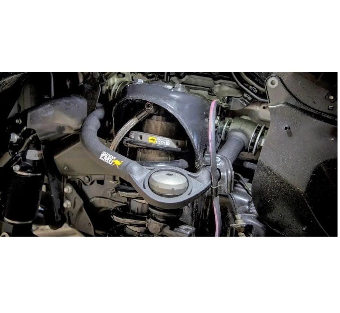 A close up of the OME Front Upper Control Arms for Toyota Hilux (2005-2022) UCA0003 by Old Man Emu, showcasing the precision in suspension lift.