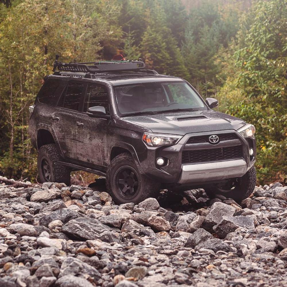 The Old Man Emu Toyota 4Runner is parked on a rocky trail, showcasing its impressive Old Man Emu Rear Coil Springs 2895 and ride height capabilities.