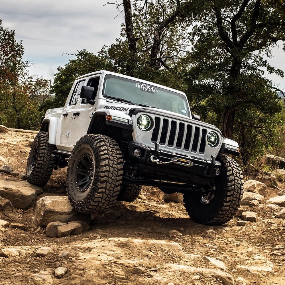 An ARB RD163 Air Locker Differential Dana 60 with 30 Splines jeep with excellent traction is driving on a rocky trail, showcasing its durability.