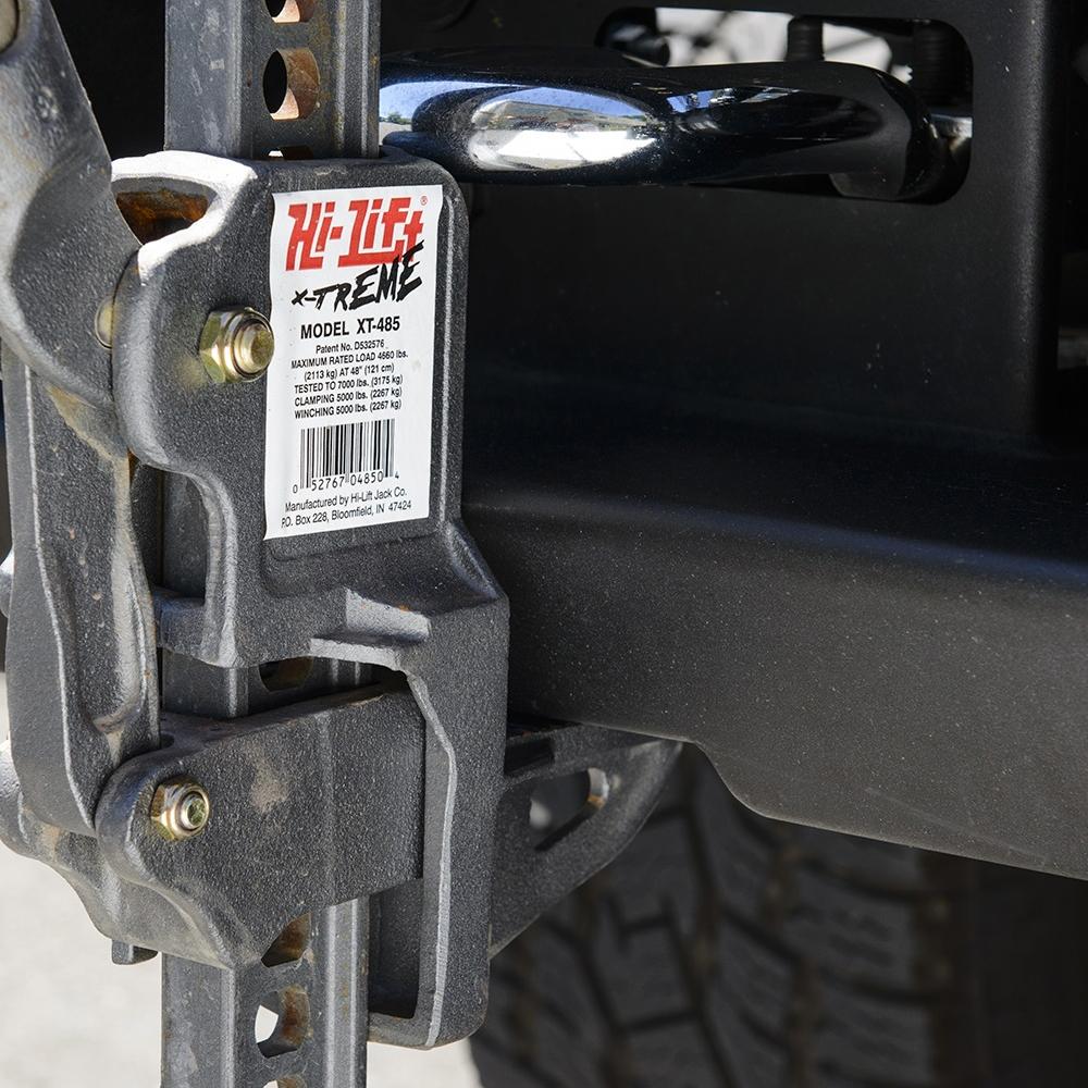 A close up of a truck with a strap attached to it, featuring secure mounting points for an Sahara Style Modular Winch Bumper Kit ARB 2236020 by ARB.