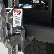Load image into Gallery viewer, A close up of a truck with a strap attached to it, featuring secure mounting points for an Sahara Style Modular Winch Bumper Kit ARB 2236020 by ARB.