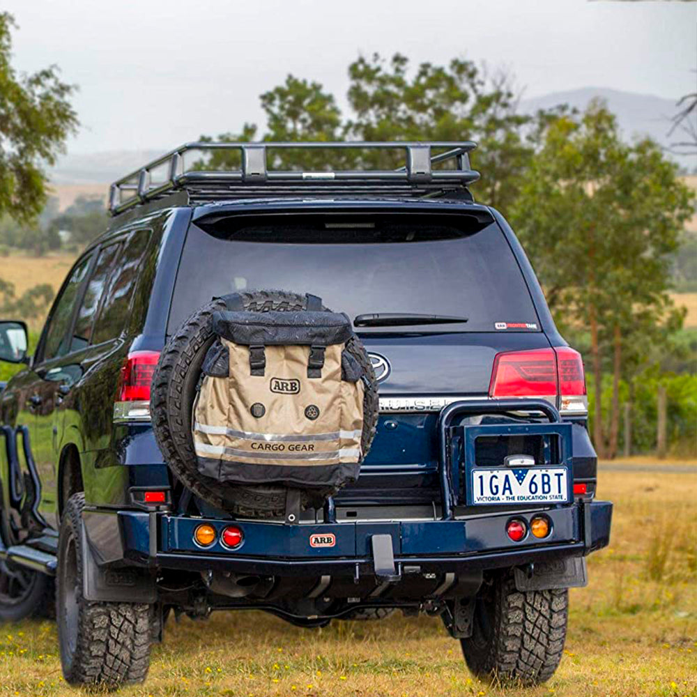 An ARB 4X4 Track Pack Series II - Cargo Gear ARB4305 is parked in a field, equipped with large compartments and removable center divider.
