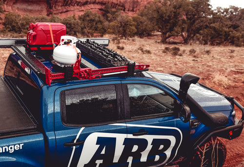 A high quality ARB Summit Step Section For Toyota Hilux Revo/Rocco (2015-2022) 4414620 blue truck is parked in a desert.