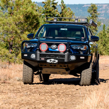 Load image into Gallery viewer, A black Toyota 4Runner with an ARB Touring Roof Rack FJ Cruiser (2007-2009) 3800200KLC2 is driving down a dirt road.