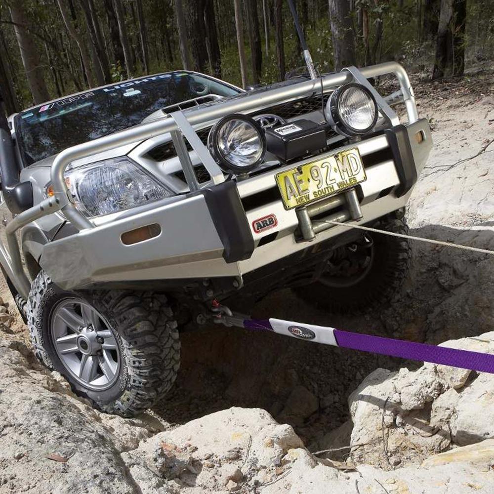An ARB Toyota Land Cruiser is stuck in a rocky area and requires an ARB Winch Extension Strap ARB725LB for recovery.