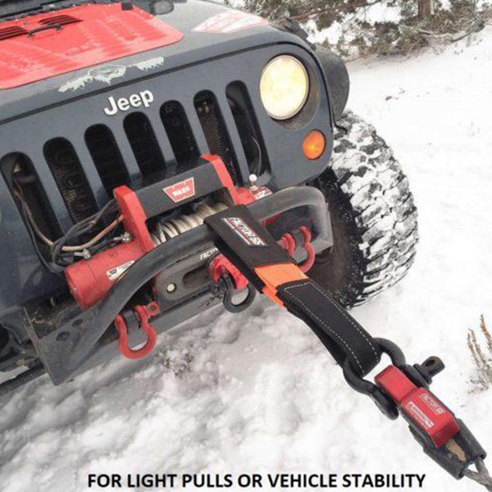 A high capacity jeep with a winch attached to it, navigating through the snow using Factor 55 Shorty Strap III 3'' x 3'' 00079 straps.