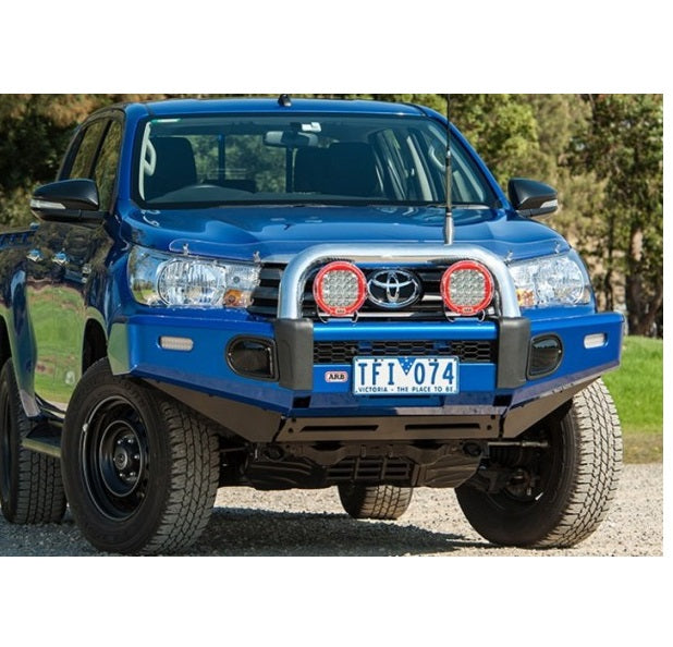 An ARB Front Top Tube With Buffer Kit For Toyota Hilux (2015-2021) 5100230, showcasing vehicle specific design and made with the highest grade materials, parked on a dirt road.