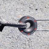 A Factor 55 Rope Retention Pulley Snatch Block 00260 with a donut attached to it, suspended by a soft shackle.