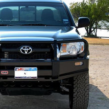 Load image into Gallery viewer, The durable front end of a black ARB Deluxe Winch Front Bumper 3423030 for Toyota Tacoma 2005 - 2011, featuring multi-fold upswept design and steel construction.