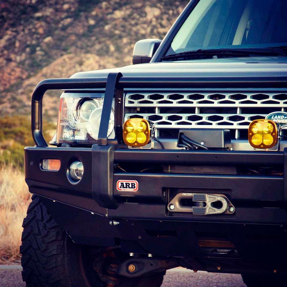 A high quality Factor 55 Hawse Offset Fairlead 1.5 in 00026 black land rover is parked on a dirt road.