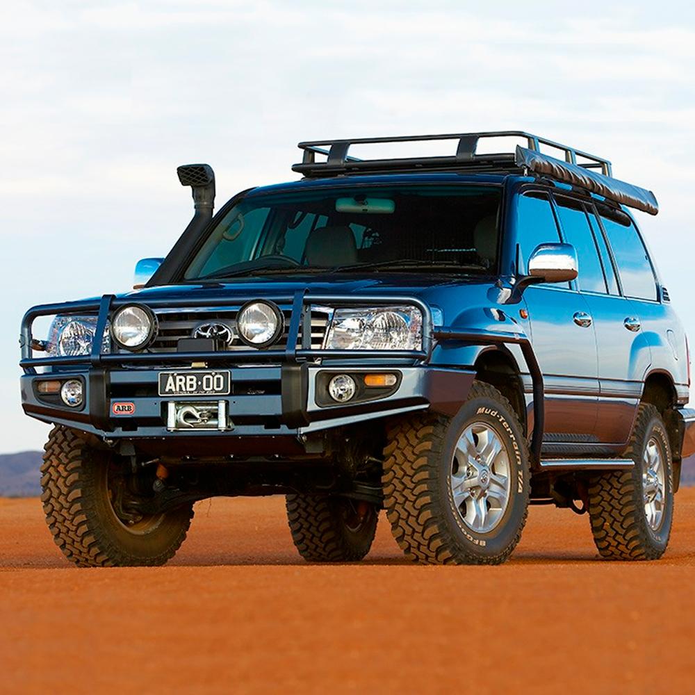 A Toyota Land Cruiser equipped with the ARB Roof Rack Fitting Kit 70” X 49” is parked in the desert.